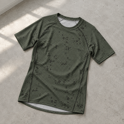 Desert Night Camo SS Rash Guard laid on a pale-gray concrete floor
